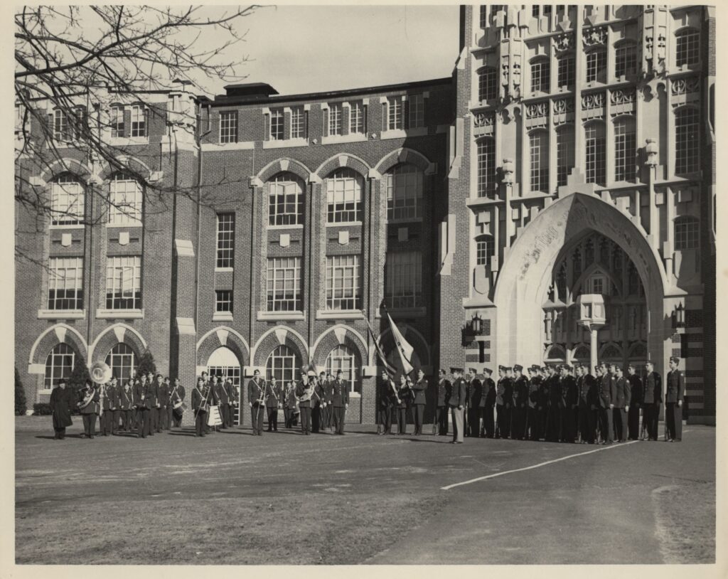 ROTC students undergo a training exercise in front of Harkins Hall in 1951