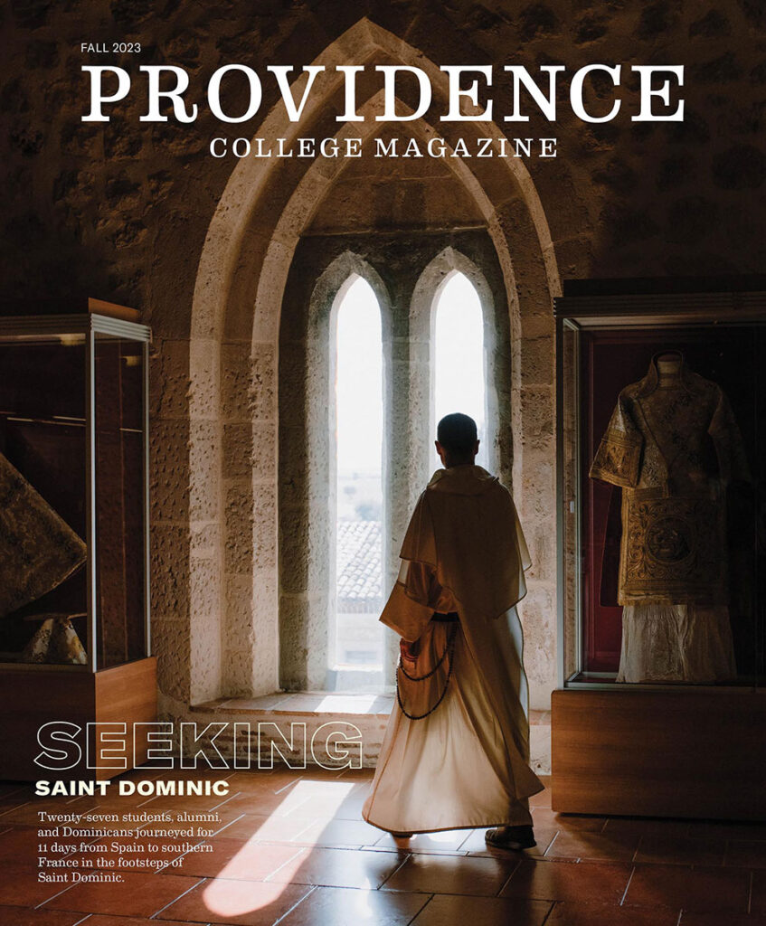 The cover of the Fall 2023 issue of Providence College Magazine featuring College Chaplain Rev. Justin Bolger, O.P., in Spain.