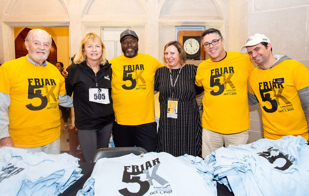 Earl Smith '92, third from left, volunteers at Homecoming in 2022 with, from left, Jim O'Leary '63, Kathleen McGinley Neiman '82, Jennifer MacCallum O'Meara '93, Brian McManus '90, and Luis Nouel '05.