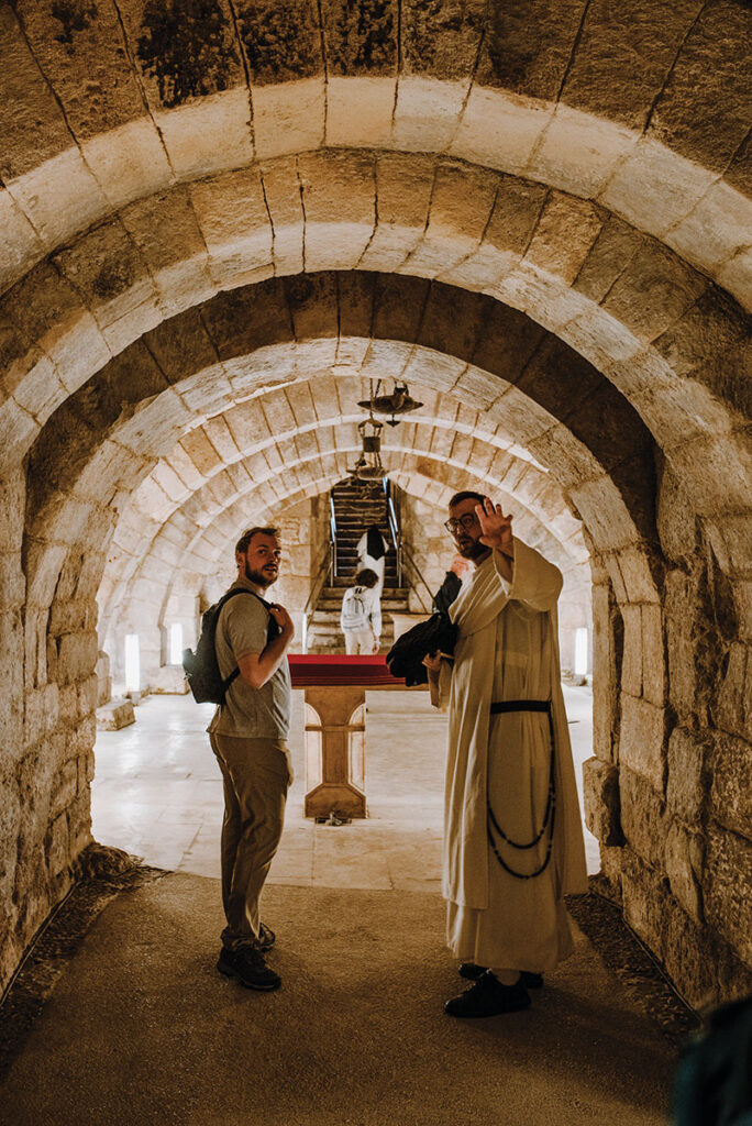 Christopher Bresnahan '23 learns about the crypt beneath the Palencia cathedral from Rev. Irenaeus Dunlevy, O.P., who has a master's degree in architecture.