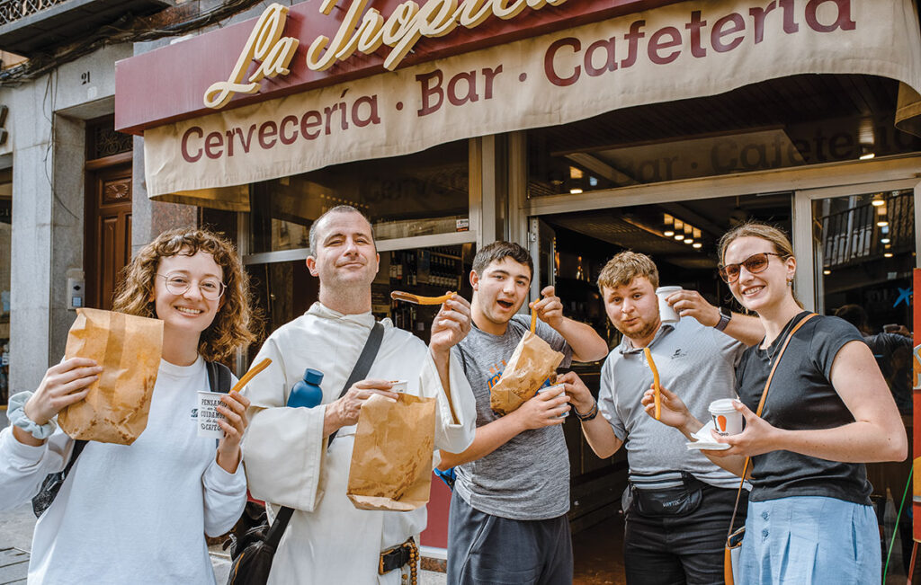 From left: Sarah Klema '23, Rev. Justin Bolger, O.P., Nicholas Baker '26, Michael Gioffre '26, and Elizabeth Duffy '23 with chocolate-dipped churros outside a café in Segovia, Spain.