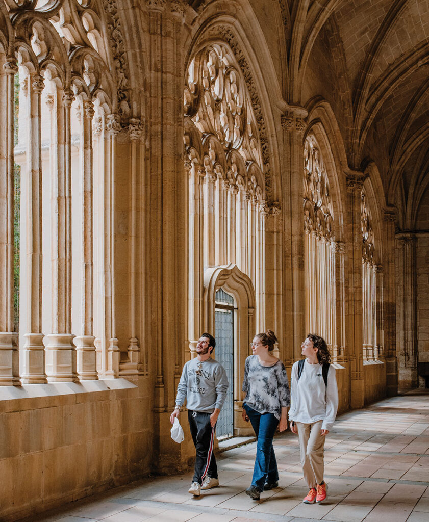 Gavin Buttafucoco '26, Claire Dancause '26, Sarah Klema '23 in the cloister adjoining the cathedral in Palencia, Spain.