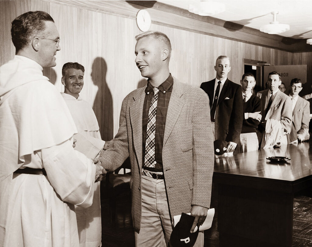 Rev. James F. Quigley, O.P. '60 at his freshman orientation in September 1956. He is being greeted by College President Rev. Robert J. Slavin, O.P. '28.