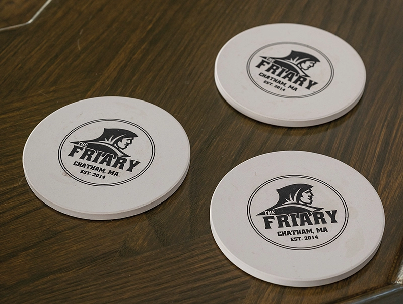 White coasts with the Friar head and the words, "Friary, Chatham, MA, Est. 2014."