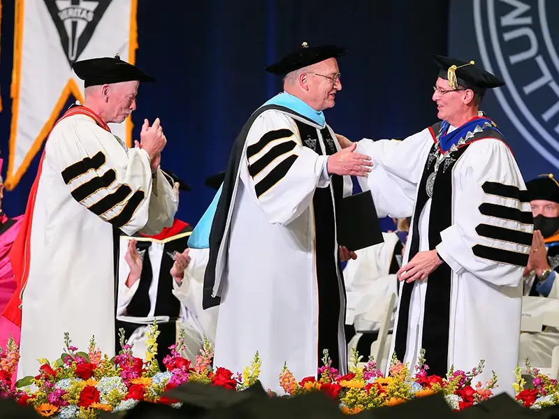 Lena receives honorary degree from Father Shanley and Father Sicard