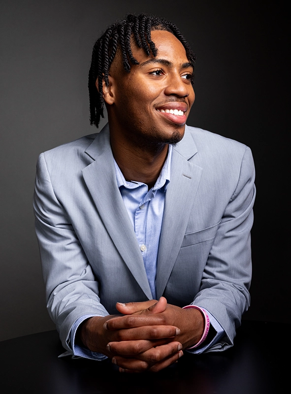 Daniel Singh '26 poses for a portrait wearing a light blue suit and blue shirt.