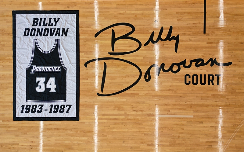 A banner for Billy Donovan '87 displayed on the floor of Billy Donovan Court in the Ruane Friar Development Center.