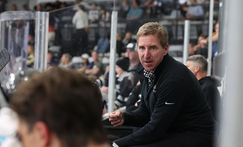 Men's hockey coach Nate Leaman directs the team during a game.