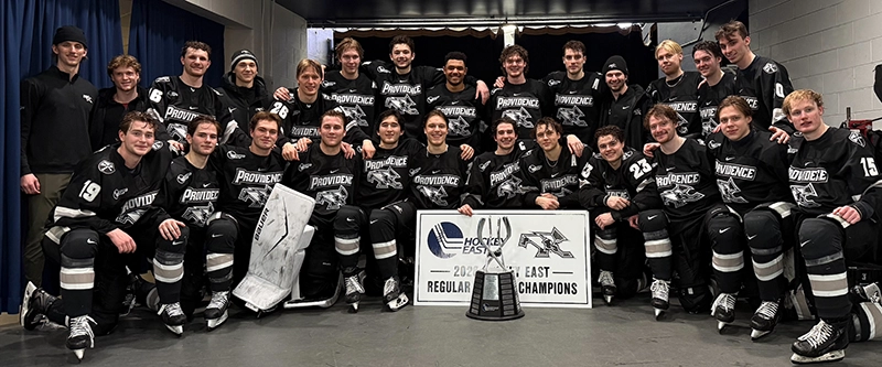 A group photo of the men's ice hockey team after winning the Hockey East regular season title.