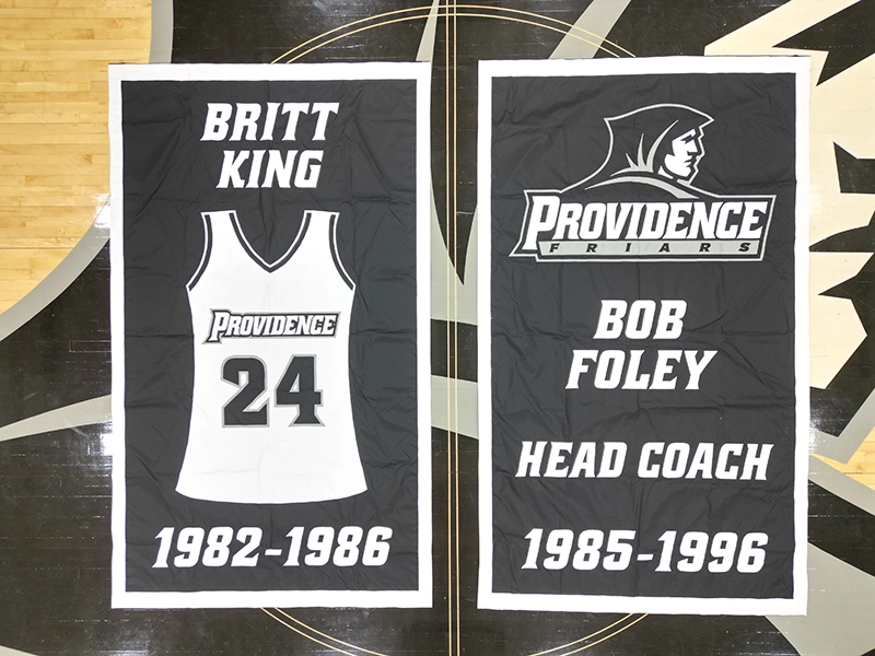 Banners honoring women's basketball player Britt King '86 and longtime women's coach Bob Foley.