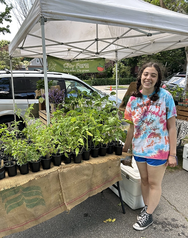 Martina Scarpa '25 representing the Southside Community Land Trust at a farmers market in Providence.