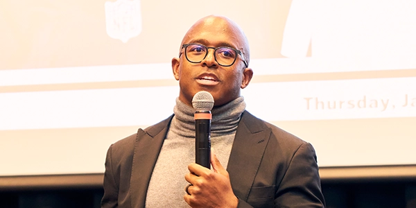 Matthew Slater, former New England Patriots football player, holds microphone at the Rev. Martin Luther King Jr. Celebration in 2025.