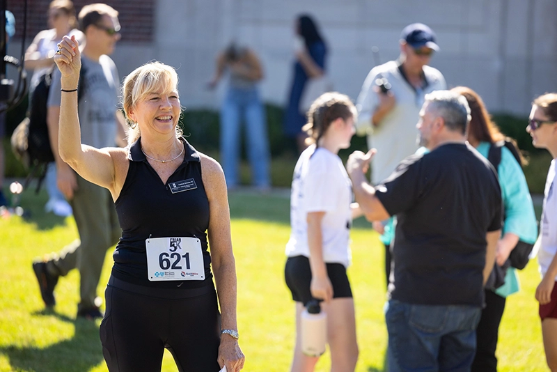 Kathleen McGinley '82 ran the Friar 5K in October 2025, but not before encouraging runners at the starting line.