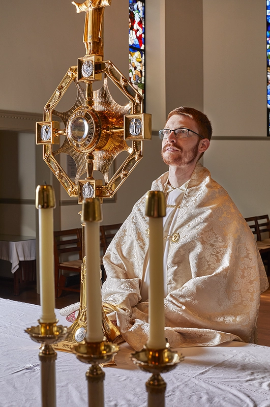 Rev. Gregory Santy, O.P., associate chaplain, with the monstrance created from donations of alumni jewelry.