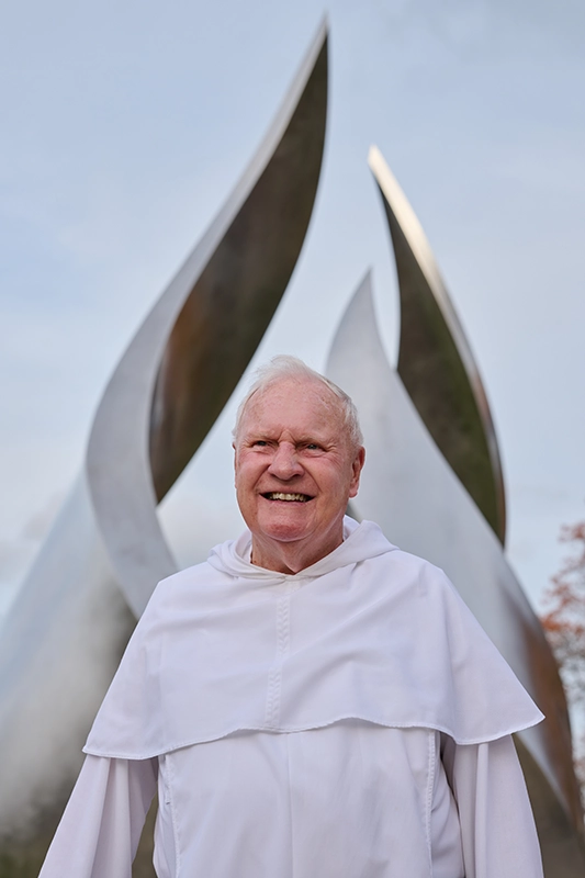 Rev. James Quigley, O.P. '60, at Calabria Plaza on campus.