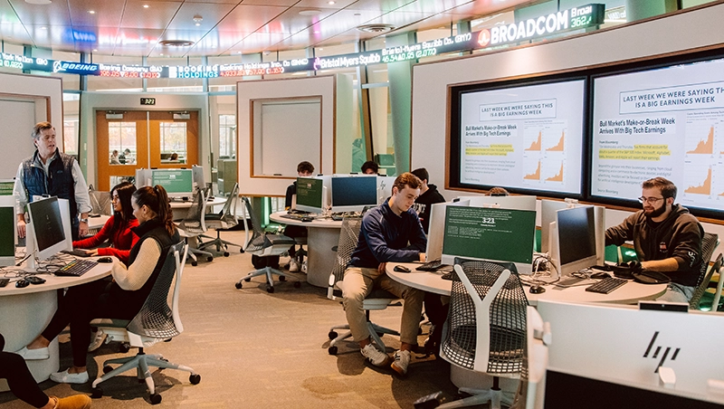 Paul Scanlon, standing, instructs students in the finance lab at the School of Business.