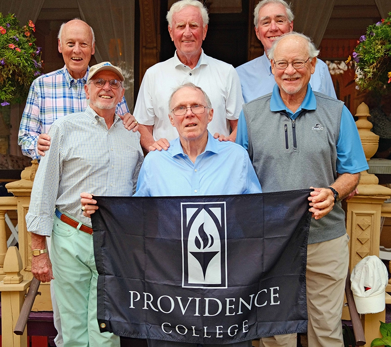 Six men from the Class of 1968 hold a banner reading "Providence College."