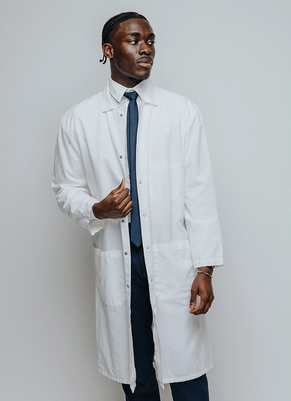 Donald Simpreus '26 in a white lab coat.