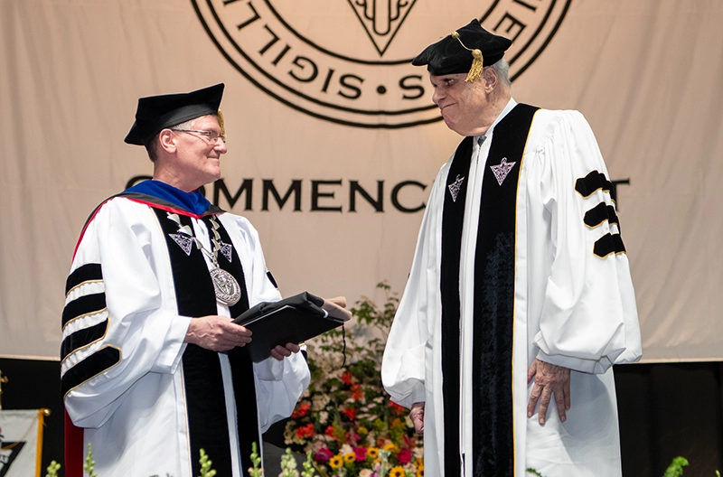 Ron Stride '62, '25Hon. receives an honorary doctor of business administration degree at commencement from College President Rev. Kenneth R. Sicard, O.P. '78, '82G.