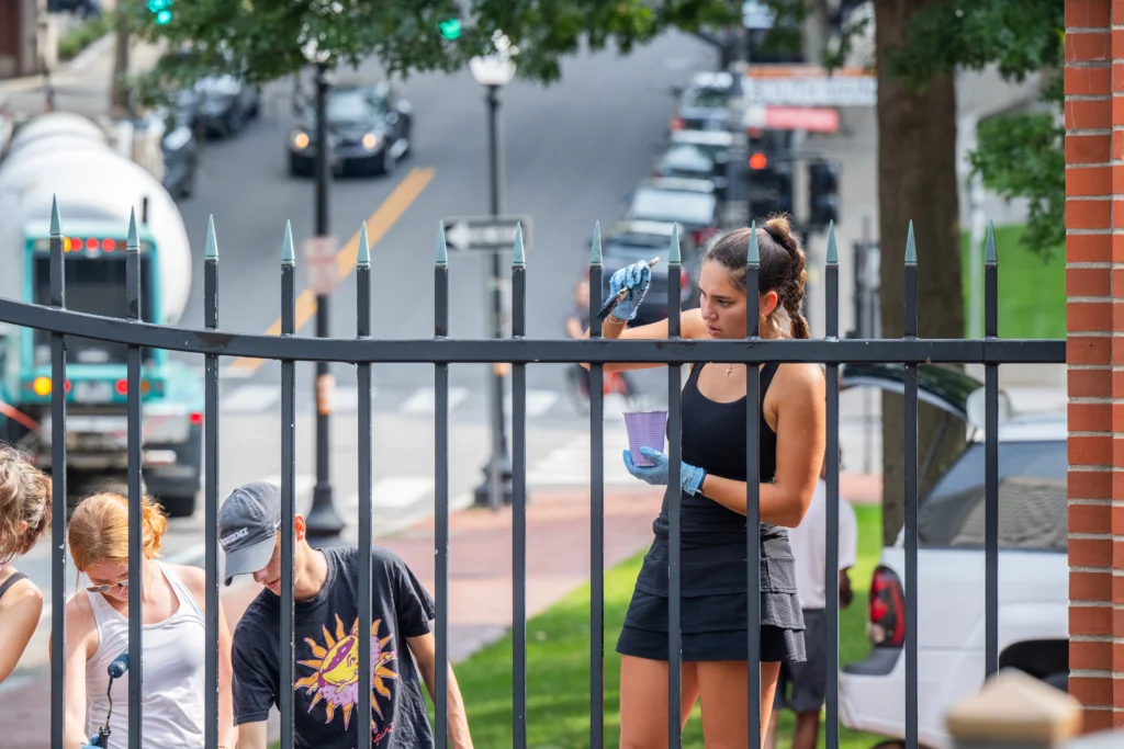 Students participating in the FaithWorks program painted the fence around Memorial Park in Providence as part of a day of service before the academic year begins.