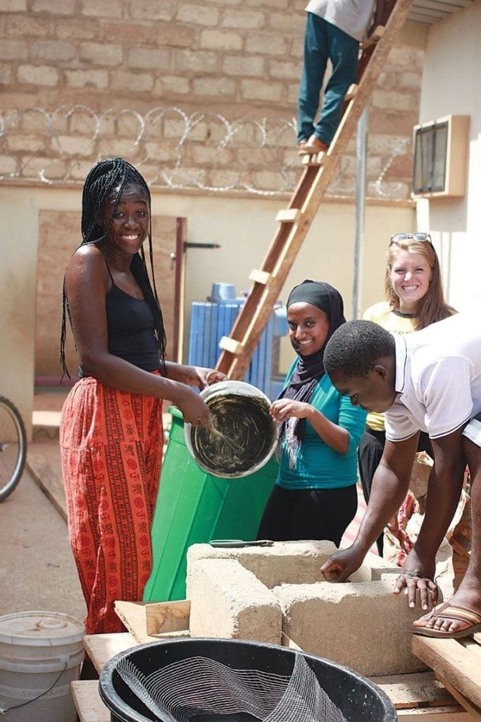 Jermoh Kamara '15, left, and Asha Ahmed '16 work on a construction project.