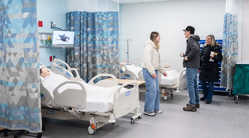 Visitors check out the Clinical Simulation Suite in the Mondor Center for Nursing and Health Sciences, made to look like the floor of a hospital.