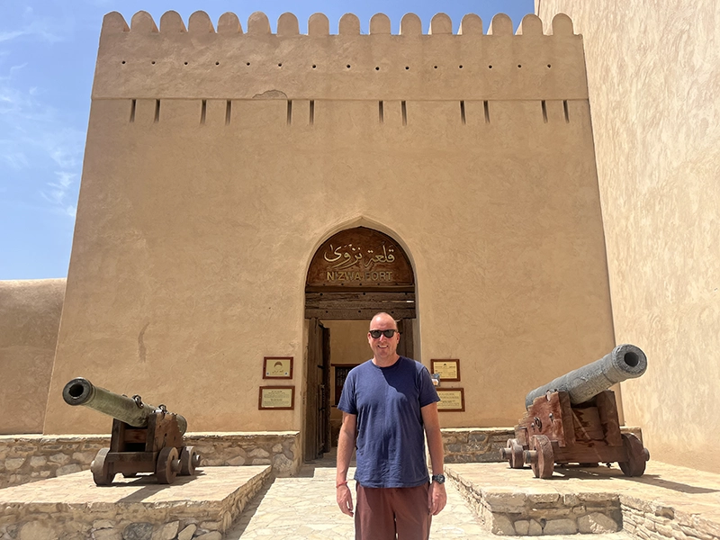 Jeff Johnson, Ph.D., in front of Nizwa Fort, a large castle built in the 17th century in Nizwa, Oman.