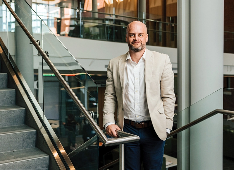 Kevin Newman, Ph.D., associate professor of marketing, inside the School of Business.