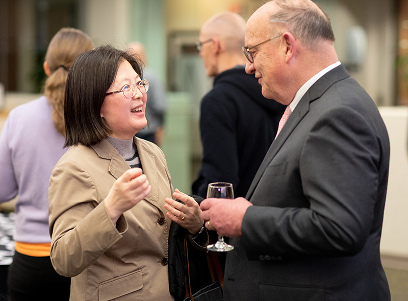 Dr. Lena with Fang Dong, Ph.D., associate professor of economics, at the spring faculty and staff meeting in March 2020.
