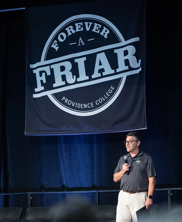 Brian McManus '90 takes the stage at Forever a Friar, an event to welcome the Class of 2028 to the community.