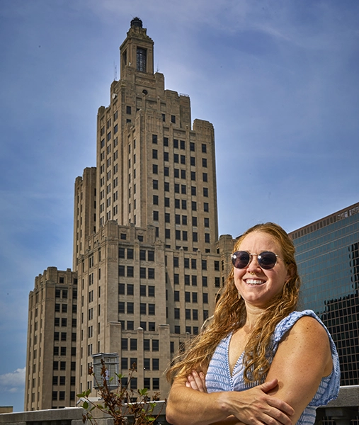 Sara Corben Harwood '14 in front of the Superman building in downtown Providence, the topic of one of her Weird Island podcast episodes.