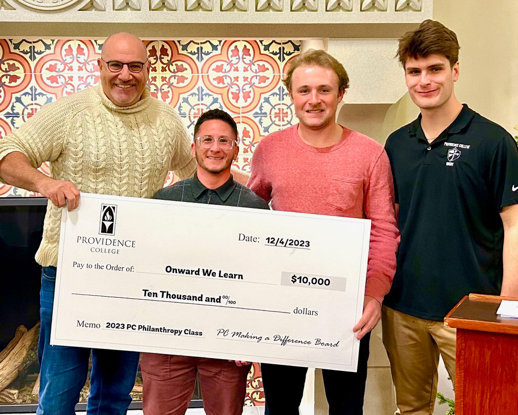 From left, Andrew Bramson, president and CEO of Onward We Learn, with Alessio Pari ‘15G, academies director, and students Brendan Driscoll '24 and Kieran Patch '24.