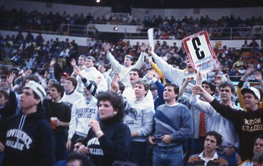 Fans cheering at Men's Basketball game