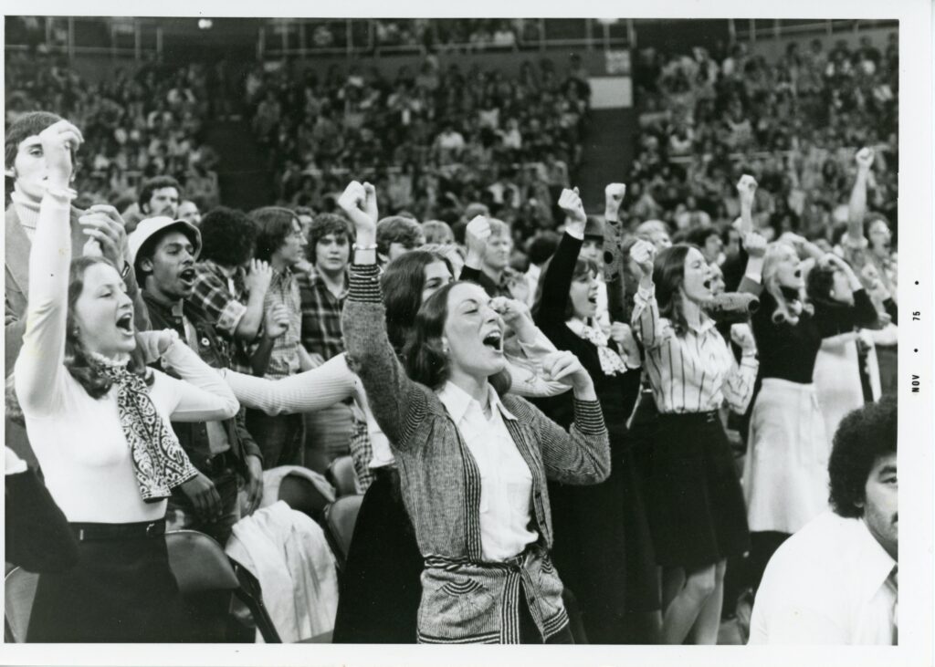 Fans cheering at Men's Basketball game 1975