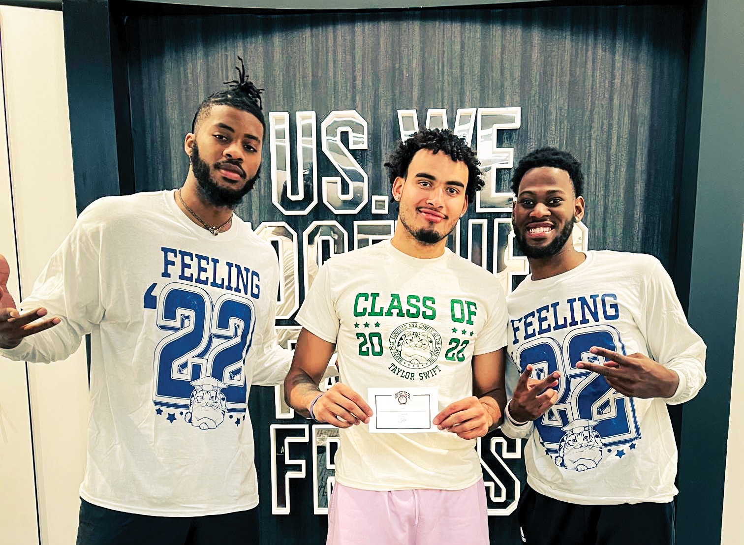 The shirts were modeled at the season ticket holder dinner in June by, from left, Nate Watson ’21, Justin Minaya, and Al Durham. Minaya holds a note from Swift.