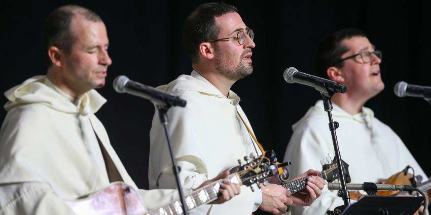 Fathers Justin Bolger, Peter Gautsch, and Simon Teller perform bluegrass music as The Hillbilly Thomists