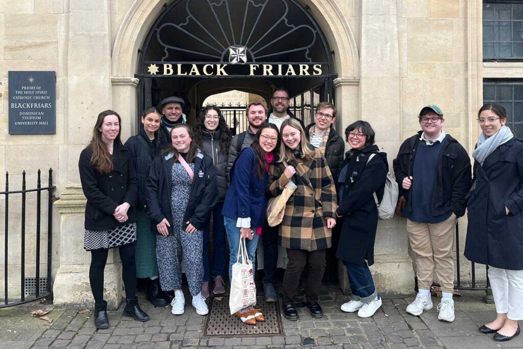 Students and faculty on CS Lewis spring break trip to Oxford in front of Blackfriars Hall