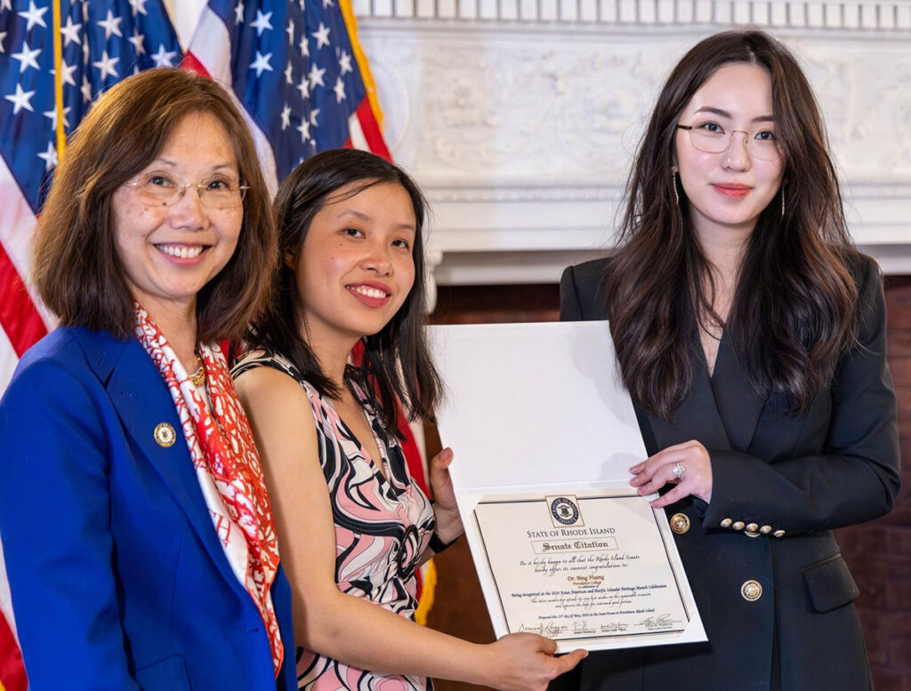 From left, Rhode Island state senators Linda Ujifusa and Victoria Gu present a citation to Bing Huang recognizing her contributions to the celebration of AANHPI heritage in Rhode Island.