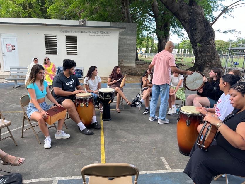 group of students sitting in a circle with musical instruments in Puerto Rico