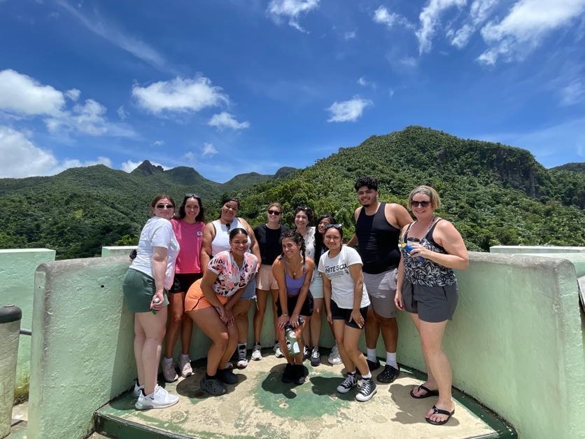 group of students posing at a scenic point on a hike in Puerto Rico