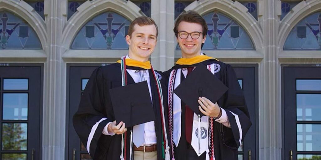 Cole Patno and Jason Sgroi in graduation gowns