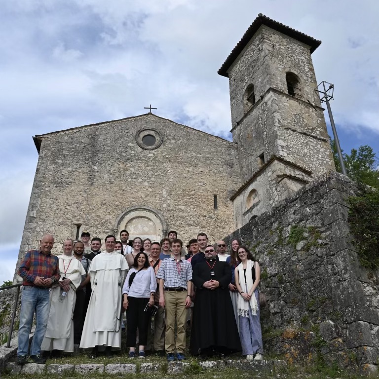 group of people standing in front of a church in Italy