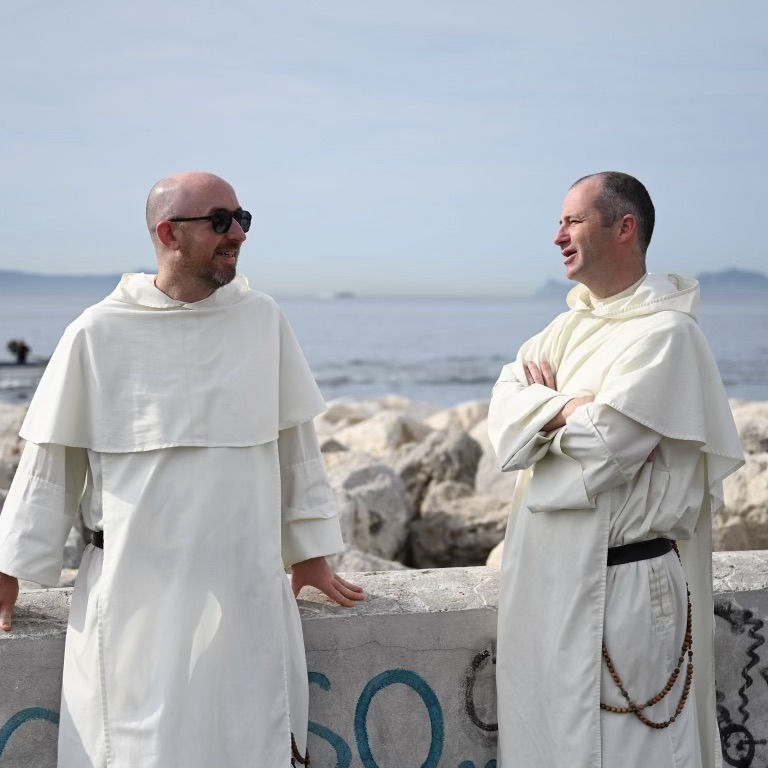 two Domincan Friars standing on the coast of Naples, Italy