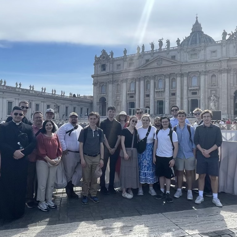 Group of people standing outside in front of a Cathedral in Italy