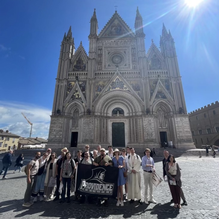 Group of people standing outside in front of the Cathedral of Orvieto in Italy