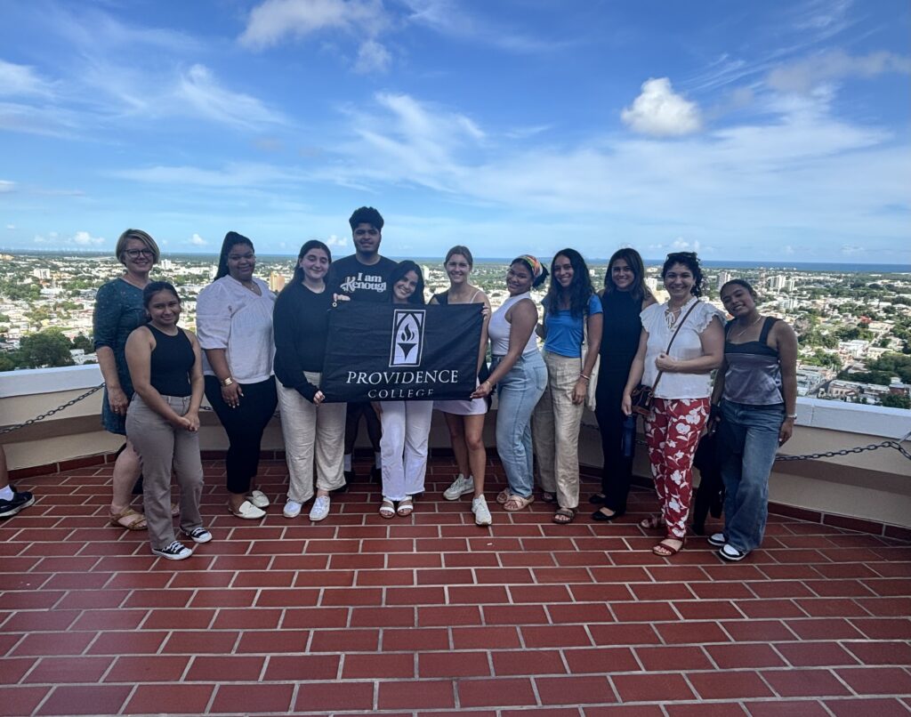 Group of students posing with a PC flag in Puerto Rico