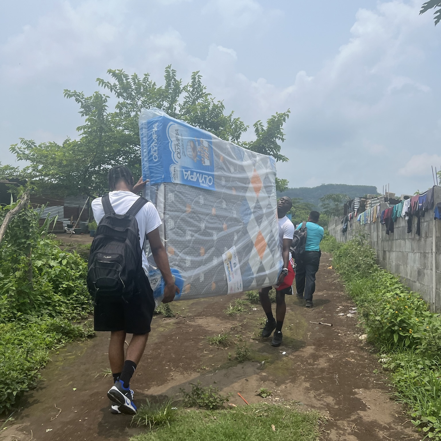 Students carrying a mattress on their service learning trip in Guatemala