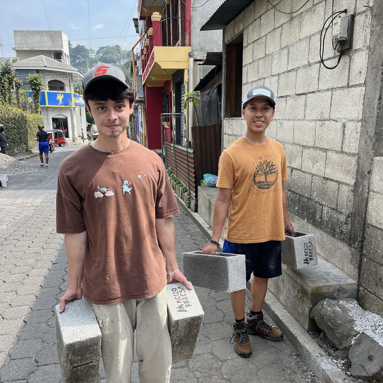 Students carrying cement blocks on a service learning trip to Guatemala