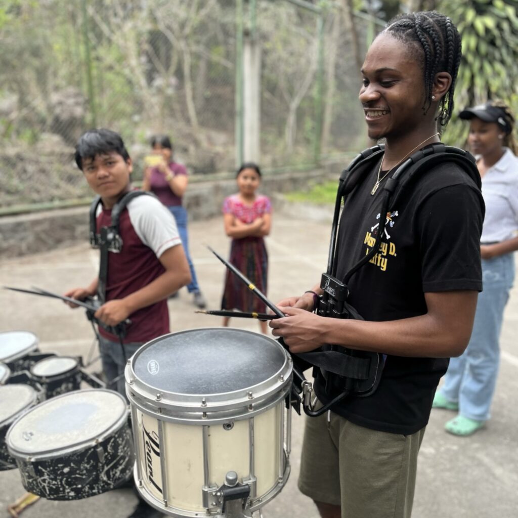 Student and local children with drums