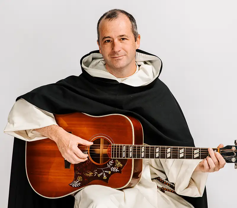 Father Justin Bolger with his guitar